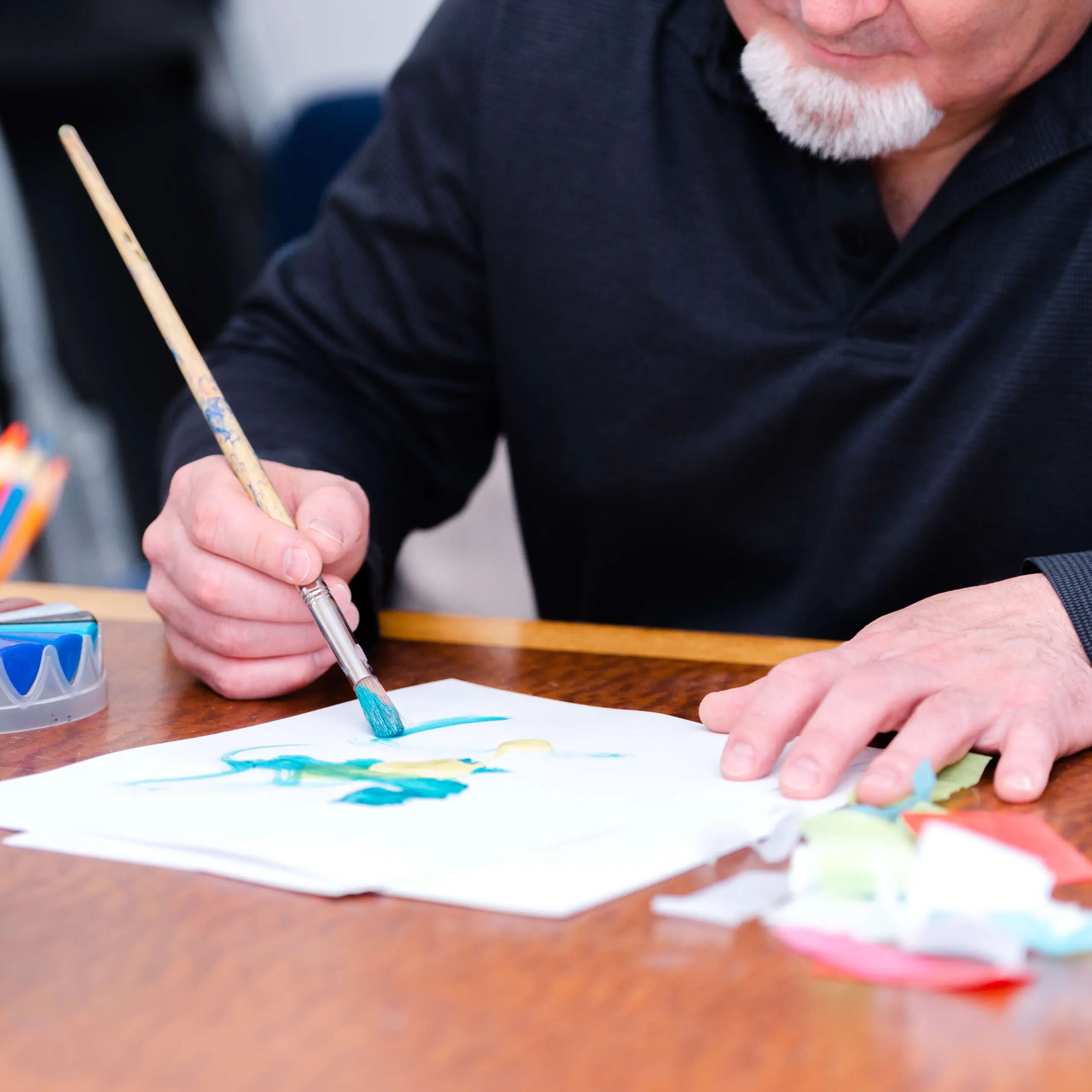 A person painting with a brush